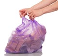 Woman's hands tied purple plastic bag with trash isolated.