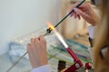 Woman's hands with tools for glass melting, lampwork, fire Royalty Free Stock Photo