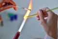 Woman's hands with tools for glass melting, the time of producti Royalty Free Stock Photo