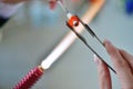 Woman's hands with tools for glass melting, the time of producti Royalty Free Stock Photo