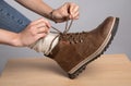 Woman's hands tying a bow on her walking boots