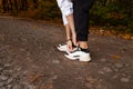 Woman& x27;s hands tying shoelaces on white sneakers. Morning run concept. Young athletic woman jogging in park or forest Royalty Free Stock Photo