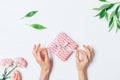 Woman's hands unwrapping small gift box