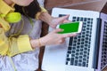 Woman`s hands using cell phone and laptop computer on floor wood Royalty Free Stock Photo