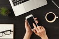 Woman`s hands using smartphone, top view Royalty Free Stock Photo