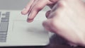 Woman's hands using a trackpad on a portable computer