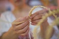 The woman`s hands weave straw Royalty Free Stock Photo