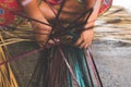 Woman`s hands weaving a krajood mat