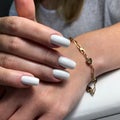 Woman`s hands with white nails