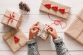 Woman`s hands wrapping christmas holiday present with craft twine Royalty Free Stock Photo