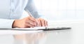 Woman`s hands writing on sheet in a clipboard with a pen, isola Royalty Free Stock Photo