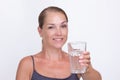 Woman of40s holding glass of pure water