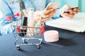 Woman`s items and cosmetics in shopping cart Royalty Free Stock Photo