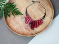 Woman`s Jewelry. Ruby necklace on wooden desk Royalty Free Stock Photo