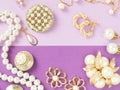 Woman`s Jewelry. Vintage jewelry background. Beautiful gold tone and pearls brooches, braceletes, necklaces and earrings on purpl Royalty Free Stock Photo