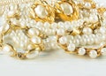 Woman`s Jewelry. Vintage jewelry background. Beautiful gold and pearl necklaces, bracelets and earrings on white wood. Flat lay, Royalty Free Stock Photo