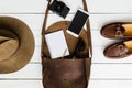 Woman's journalist or traveler accessories on white wooden table background flat lay. Brown leather purse, marine shoes, camera, Royalty Free Stock Photo