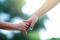 Woman`s and kid`s hands. Mother lead his child, summer nature outdoor. Parenting, togetherness, help, union, childhood, trust, Royalty Free Stock Photo