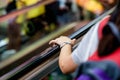 A woman`s left hand was holding an escalator`s handrail Royalty Free Stock Photo