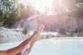 Woman`s leg close up, skin care with white natural mud, bathing in geothermal pool and hot spring in Tuscany, Italy. Bagni San Royalty Free Stock Photo