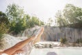 Woman`s leg close up, skin care with white natural mud, bathing in geothermal pool and hot spring in Tuscany, Italy. Bagni San Royalty Free Stock Photo