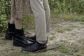 Woman`s legs in black boots and man`s legs in black boots Royalty Free Stock Photo