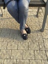 Woman`s legs in blue jeans and black pumps shoes Royalty Free Stock Photo