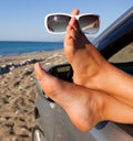 Woman's legs dangling out a car window Royalty Free Stock Photo