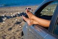 Woman's legs dangling out a car window Royalty Free Stock Photo