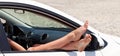 Woman's legs dangling out a car window Royalty Free Stock Photo