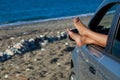 Woman's legs dangling out a car window Royalty Free Stock Photo