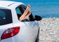 Woman`s legs dangling out a car Royalty Free Stock Photo