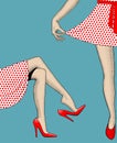 Woman`s legs and hand pull the edge of the polka-dot dress