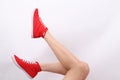 Woman`s legs with Red Tomy Takkie Trainers Royalty Free Stock Photo