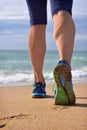 Woman's legs, runner's legs ocean beach. Royalty Free Stock Photo
