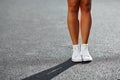 Woman`s legs in sneakers - close up.