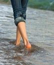 Woman's legs walking along the seacoast Royalty Free Stock Photo