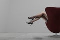Woman`s Legs Wearing Pantyhose and High Heels in modern interior Royalty Free Stock Photo