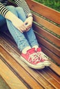 Woman`s legs wearing red canvas sneakers Royalty Free Stock Photo