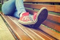 Woman`s legs wearing red canvas sneakers Royalty Free Stock Photo