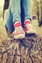 Woman`s legs wearing red canvas sneakers Royalty Free Stock Photo