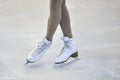 Woman's Legs in White Ice Skates