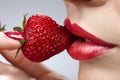 Woman`s mouth with red strawberry Royalty Free Stock Photo