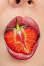 Woman`s mouth with strawberry Royalty Free Stock Photo