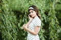 Close-up portrait of young beautiful Russian brunette girl at summer green park Royalty Free Stock Photo