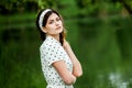 Close-up portrait of young beautiful Russian brunette girl at summer green park Royalty Free Stock Photo