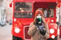 Woman`s portrait in warm winter clothes stands with a cup of coffee and a smartphone in her hands Royalty Free Stock Photo