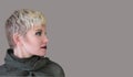 Woman`s profile portrait blonde. Fashion hairstyle, haircut, makeup in grey shades. Royalty Free Stock Photo