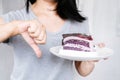 Woman's Resolute Gesture: Rejecting Sugar Temptation by Refusing to Indulge in Cake and Sweet Desserts