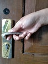 The woman`s right hand, holding the doorknob, trying to open